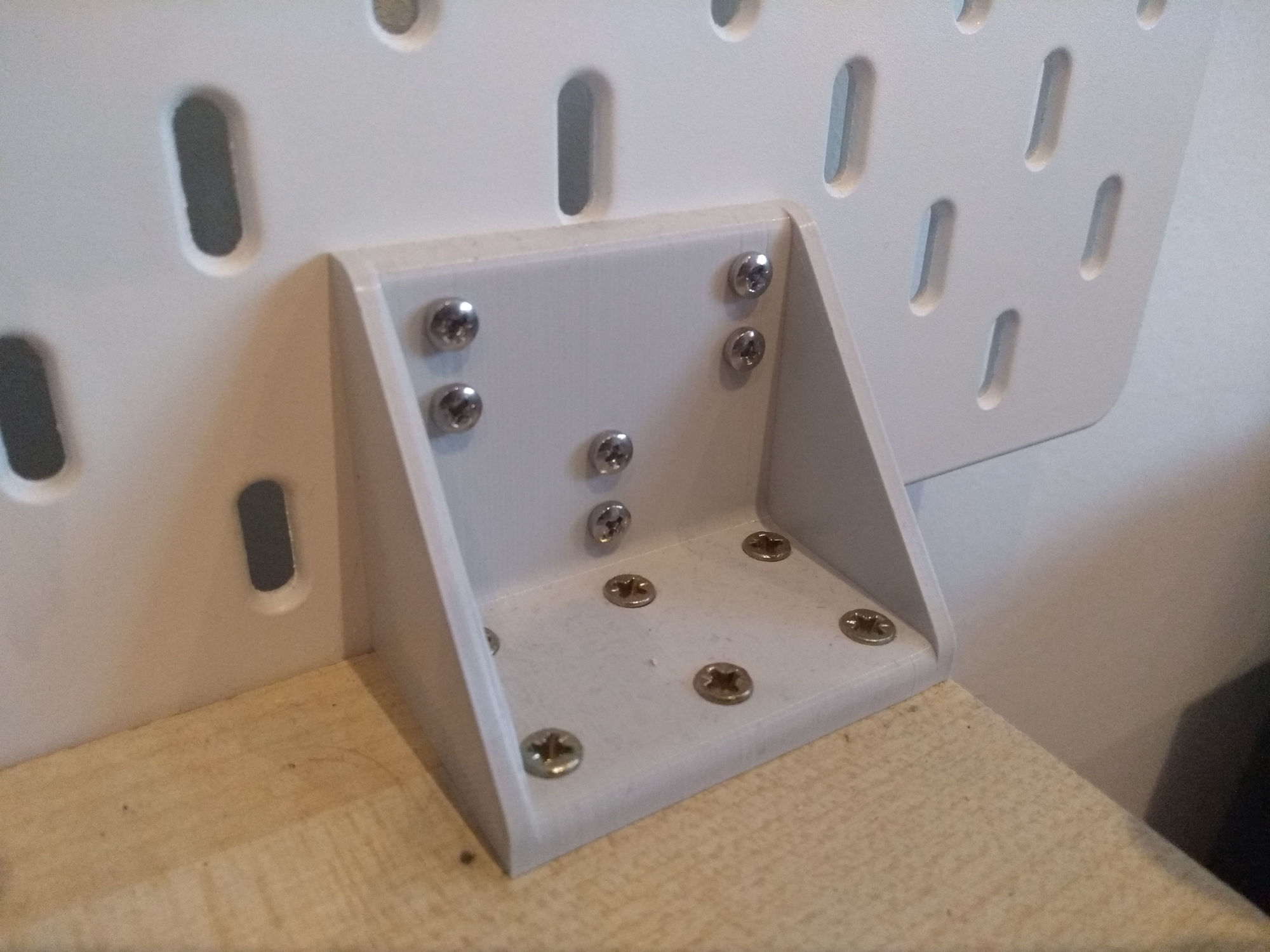 The mounting bracket installed, supporting the pegboard Close-up of the mounting bracket