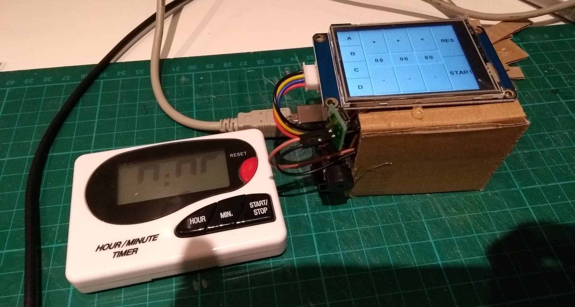 Basic kitchen timer with a broken screen, next to the initial mockup of my timer - an Arduino and touchscreen held together with cardboard and wires