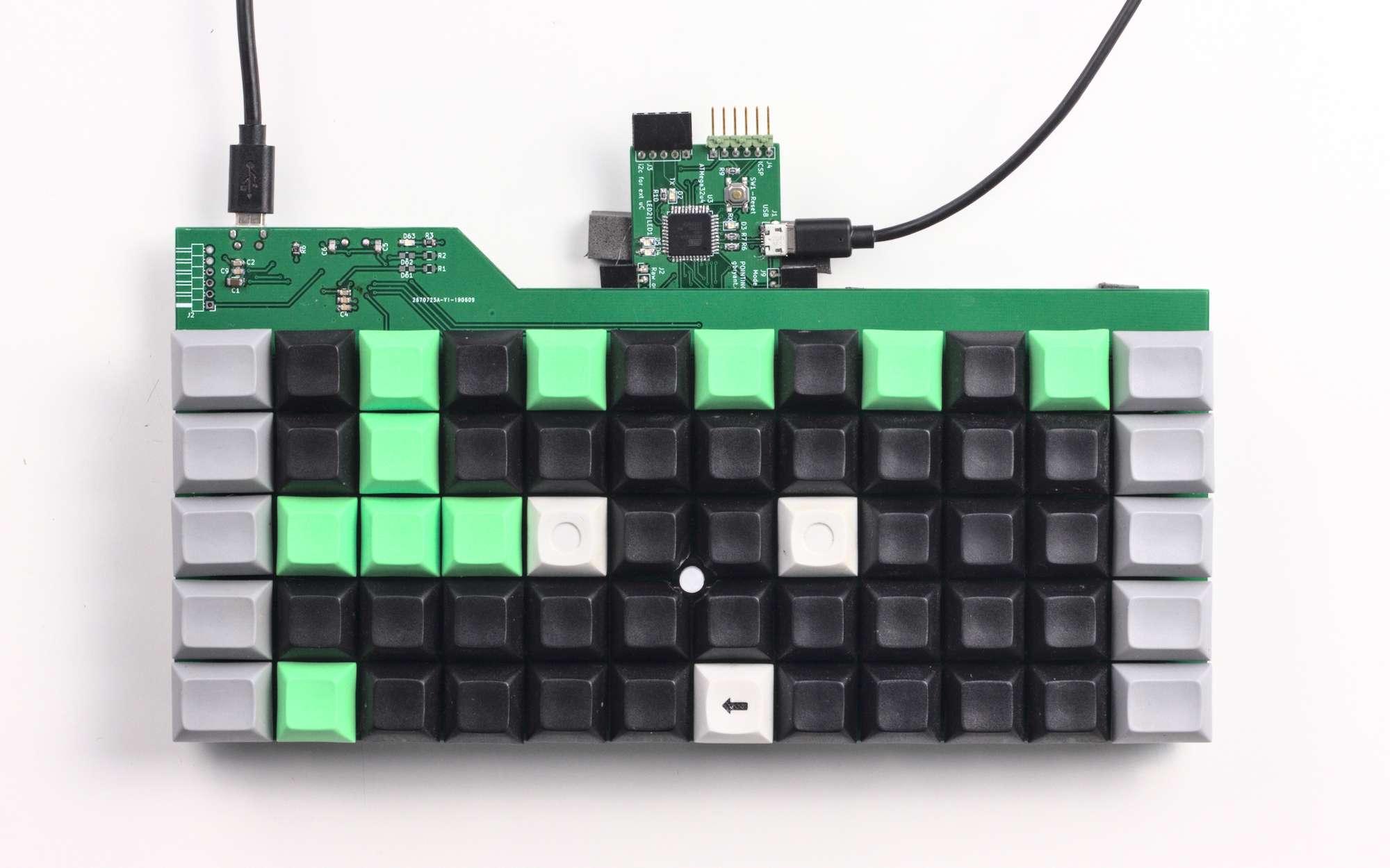 Other than the PCB poking out the top it looks pretty slick! The whole keyboard, with a white pointing stick nub in the middle, and the PCB poking out the top edge
