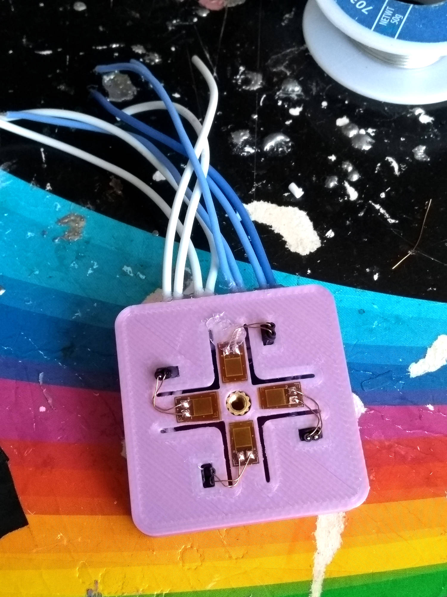 Outer side of the strain gauge mount - note the tiny wires Strain gauges mounted to the 3D print and wired up, using tiny wires which connect to larger wires
