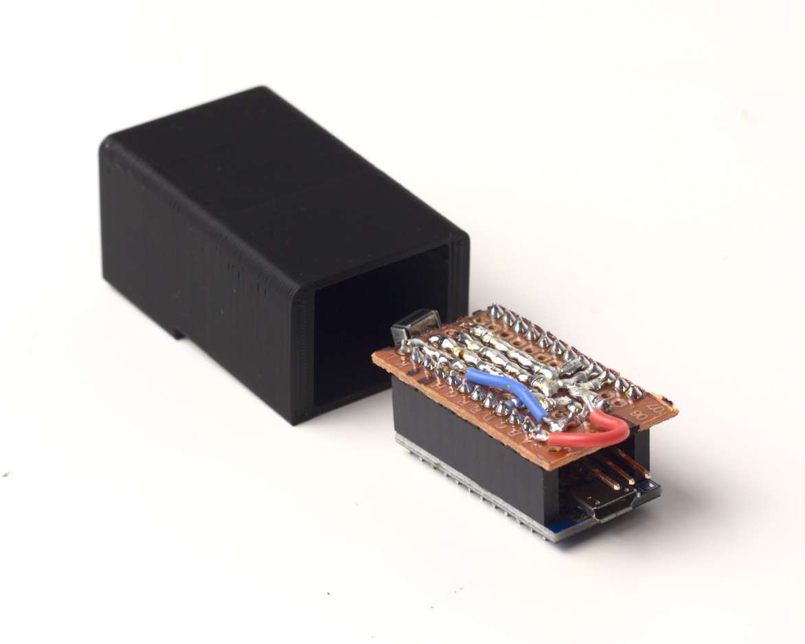 The circuit pretty much just wedges in there. I got lucky with the sizing. Small stripboard circuit the size of an Arduino Pro Micro, mounted on top of one. The front has an IR receiver sticking out. The rear has a three-pin header for the servo. Next to it is a small 3D printed box for it.