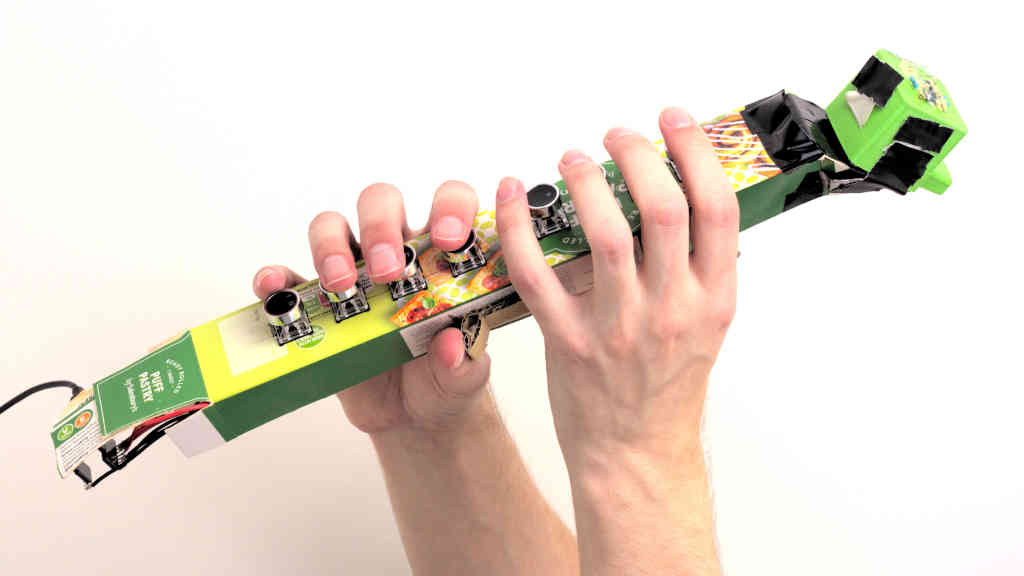 Electro-sax prototype held aloft